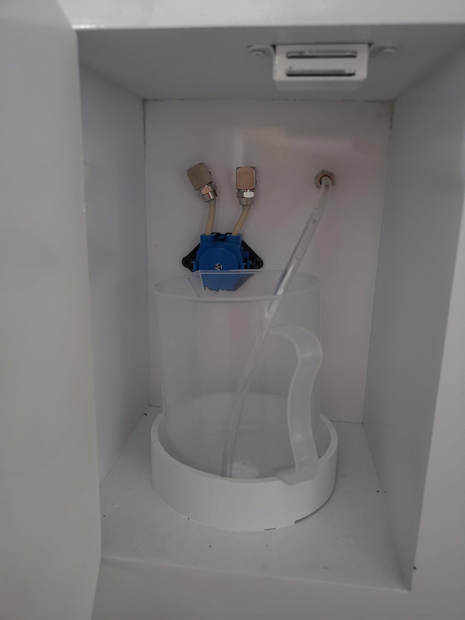 Peristaltic pump mechanism showing rotating rollers and flexible tubing