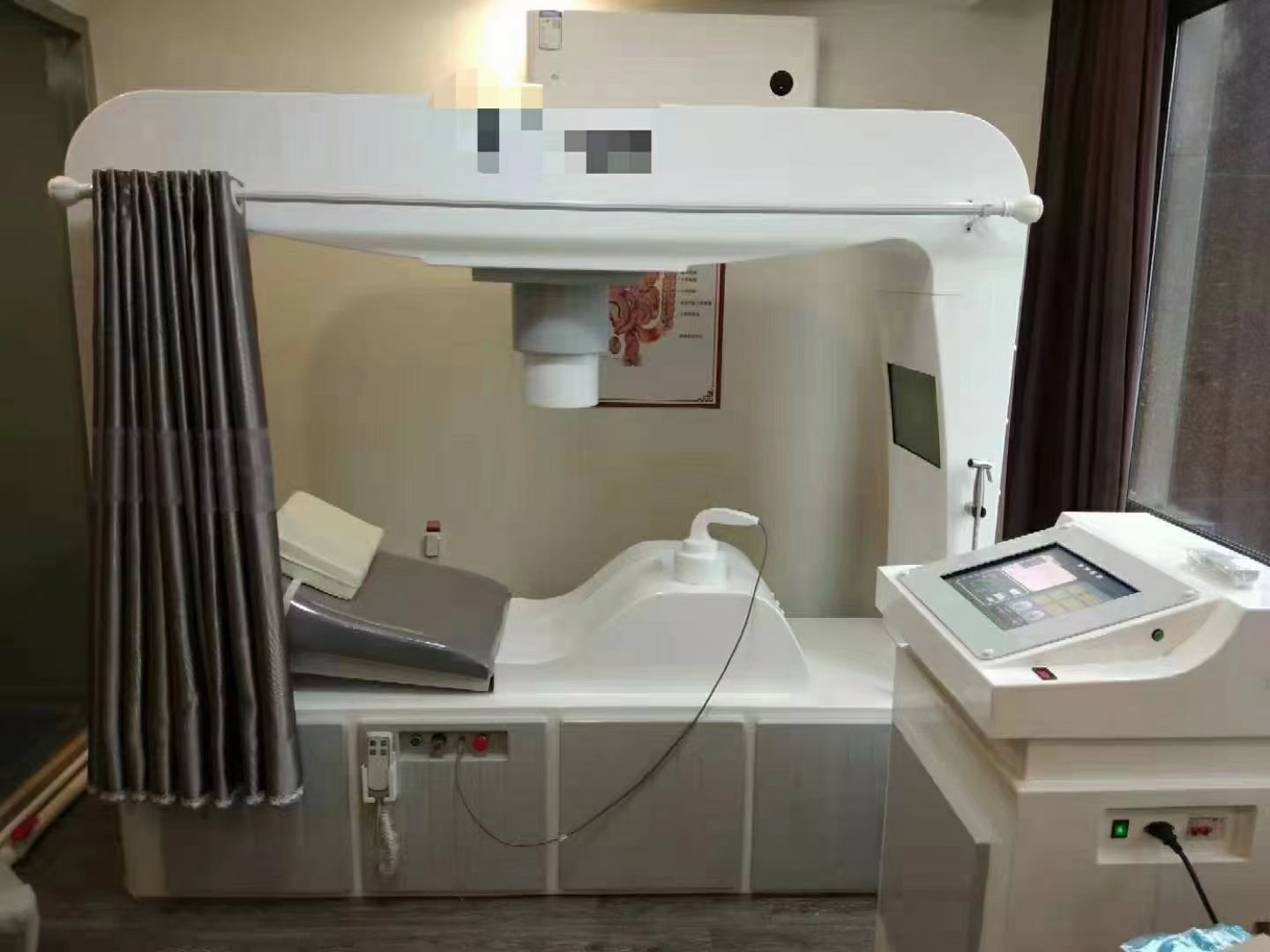 Happy clinic owner with MAIKONG colonic machine in professional setting