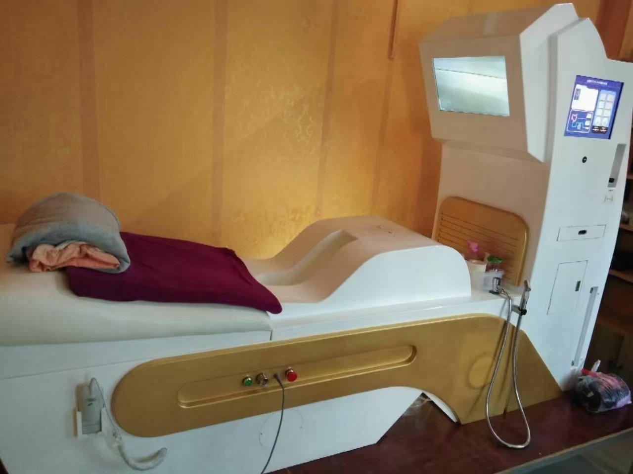 Modern colonic hydrotherapy treatment room with professional equipment