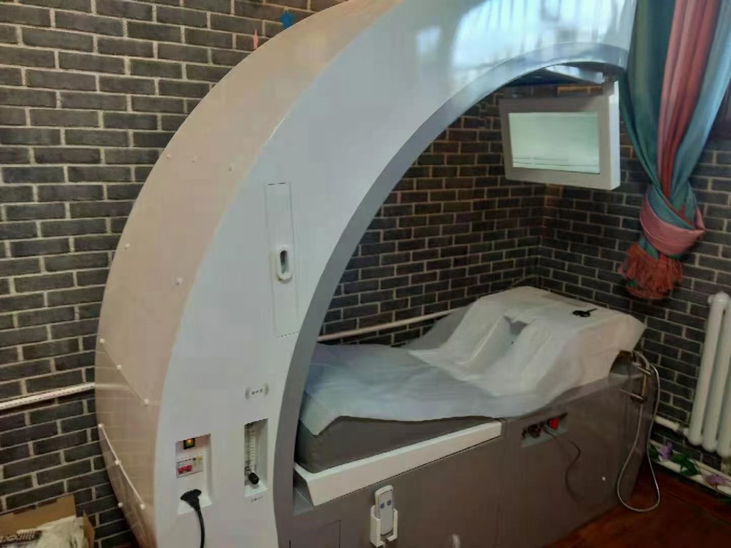 UK spa owner reviewing colonic machine OEM branding options on tablet