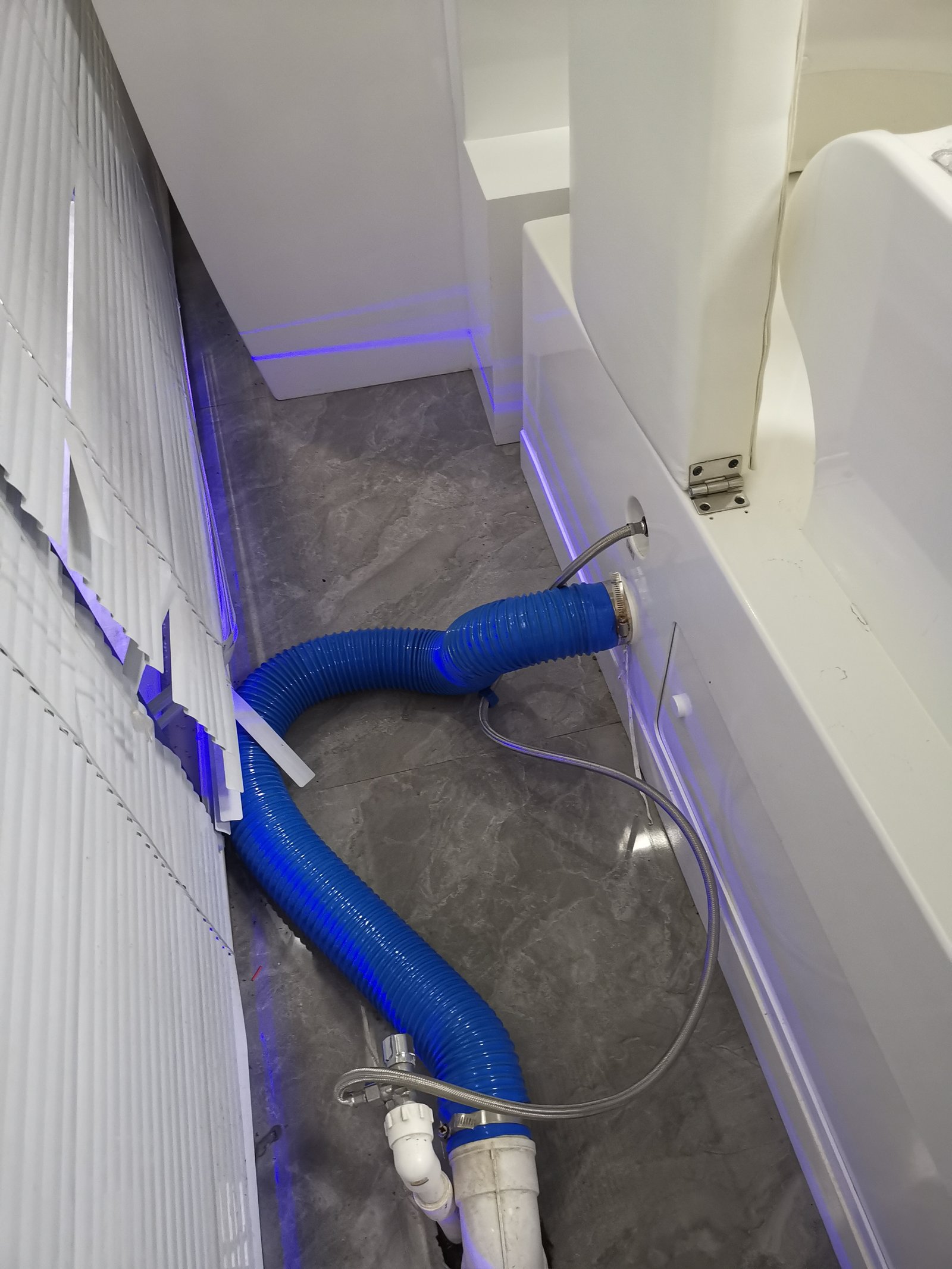 Professional installation of colonic machine showing plumbing and electrical connections